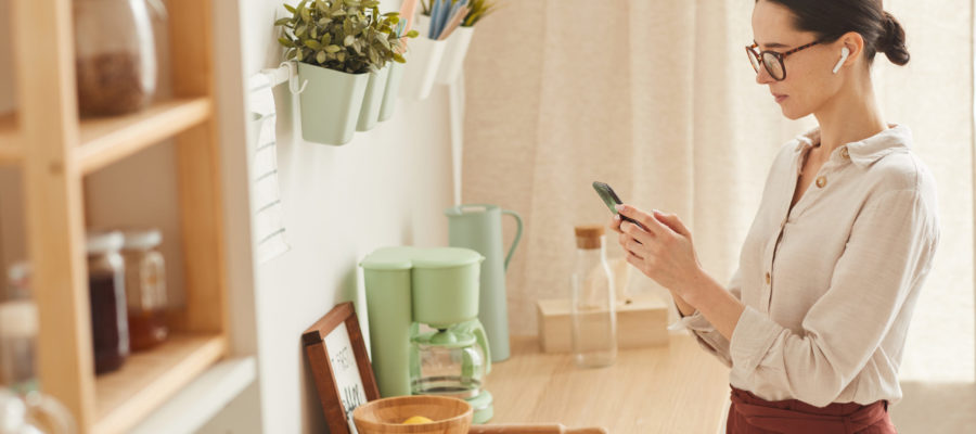 Elegant Woman Using Smartphone at Home